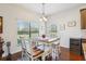 Bright dining area with a large window and a rustic-style table at 10642 Mistflower Ln, Tampa, FL 33647