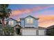 Beautiful two-story home with stucco siding, stacked stone accents, and three-car garage at 10642 Mistflower Ln, Tampa, FL 33647