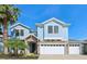 Charming two-story home with stone accents, a three-car garage, and a well-manicured lawn at 10642 Mistflower Ln, Tampa, FL 33647