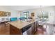 Large kitchen island featuring granite countertops and stainless steel dishwasher at 10642 Mistflower Ln, Tampa, FL 33647