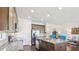 Modern kitchen with granite countertops and stainless steel appliances, seamlessly flowing into the living area at 10642 Mistflower Ln, Tampa, FL 33647
