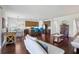 Spacious open-concept living area with hardwood floors and a modern kitchen in the background at 10642 Mistflower Ln, Tampa, FL 33647