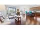 Open concept living room with hardwood floors and large windows at 10642 Mistflower Ln, Tampa, FL 33647