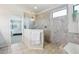 The main bathroom offers a tiled glass shower, large tub, and neutral colors at 10642 Mistflower Ln, Tampa, FL 33647