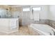 Bright main bathroom featuring a large shower and soaking tub at 10642 Mistflower Ln, Tampa, FL 33647