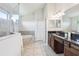 The main bathroom features a soaking tub, large vanity, and glass shower at 10642 Mistflower Ln, Tampa, FL 33647
