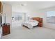 Spacious main bedroom features carpet, and a large window for natural light at 10642 Mistflower Ln, Tampa, FL 33647