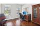 Bright home office featuring hardwood floors, a large window, and built-in shelves at 10642 Mistflower Ln, Tampa, FL 33647