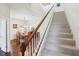 Carpeted staircase leading upstairs, with a view of the dining and living areas at 10642 Mistflower Ln, Tampa, FL 33647