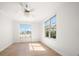 Sun-filled bedroom features light wood floors, a ceiling fan and two large windows with outdoor views at 11 San Marco St # 307, Clearwater Beach, FL 33767