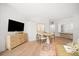 Open floor plan of a dining room with sleek furniture adjacent to an open kitchen with barstool seating at 11 San Marco St # 307, Clearwater Beach, FL 33767