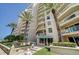 Luxury condo building showcasing multiple balconies and lush landscaping at 11 San Marco St # 307, Clearwater Beach, FL 33767