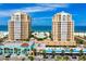 Beautiful waterfront condo buildings with beach views and colorful storefronts below on a sunny day at 11 San Marco St # 307, Clearwater Beach, FL 33767