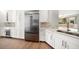Modern kitchen with stainless steel appliances, marble countertops, and ample white cabinetry at 11 San Marco St # 307, Clearwater Beach, FL 33767