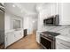 Open kitchen featuring stainless steel appliances, marble countertops, and bright lighting at 11 San Marco St # 307, Clearwater Beach, FL 33767