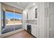 Kitchen bar area boasting a wine cooler, storage cabinets, and access to an outdoor balcony at 11 San Marco St # 307, Clearwater Beach, FL 33767