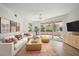 Bright living room with modern furniture, decorative rug, and sliding glass doors to the outdoor patio at 11 San Marco St # 307, Clearwater Beach, FL 33767