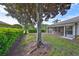 Scenic backyard with shade trees and a screened lanai at 1171 Corinth Greens Dr, Sun City Center, FL 33573