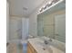 Bathroom with a tub behind a shower curtain, tile floors, and a vanity at 1171 Corinth Greens Dr, Sun City Center, FL 33573