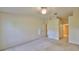 A beige colored bedroom with carpet, with multiple doorways and a ceiling fan at 1171 Corinth Greens Dr, Sun City Center, FL 33573