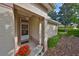 Close-up of the home's entrance, showcasing a covered porch and decorative plants at 1171 Corinth Greens Dr, Sun City Center, FL 33573