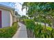 Well-maintained walkway surrounded by lush green bushes and a variety of plants at 1171 Corinth Greens Dr, Sun City Center, FL 33573
