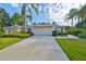 Charming home with a well-maintained front yard and beautiful landscaping and a long driveway at 1171 Corinth Greens Dr, Sun City Center, FL 33573