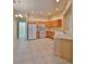 Bright kitchen with wood cabinets, white appliances, and tile flooring at 1171 Corinth Greens Dr, Sun City Center, FL 33573