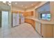 Bright kitchen with wood cabinets, white appliances, and tile flooring at 1171 Corinth Greens Dr, Sun City Center, FL 33573