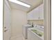 Convenient laundry room featuring a washer, dryer, and storage cabinets at 1171 Corinth Greens Dr, Sun City Center, FL 33573