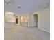 Spacious living room with neutral walls, open layout to dining and kitchen, and ample lighting at 1171 Corinth Greens Dr, Sun City Center, FL 33573