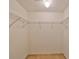 Empty walk-in closet with hanging racks ready for customization at 1171 Corinth Greens Dr, Sun City Center, FL 33573