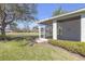 Exterior of home with a screened-in lanai overlooking a lush lawn and tranquil pond at 1205 Huntington Greens Dr, Sun City Center, FL 33573