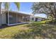 Scenic view of the backyard and neighboring lanais with view of a tranquil pond at 1205 Huntington Greens Dr, Sun City Center, FL 33573