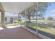 Enclosed lanai offering serene views of the pond and surrounding landscape at 1205 Huntington Greens Dr, Sun City Center, FL 33573
