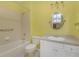 Well-lit bathroom featuring a tub, shower, and a vanity with a large mirror at 1205 Huntington Greens Dr, Sun City Center, FL 33573