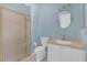Bathroom featuring a glass-enclosed shower, a vanity with sink, toilet, and blue painted walls at 1205 Huntington Greens Dr, Sun City Center, FL 33573