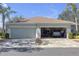 A home's two-car garage with an open door showing storage and organization at 1205 Huntington Greens Dr, Sun City Center, FL 33573