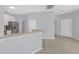 Modern kitchen featuring stainless steel appliances and ample counter space, transitioning to additional living space at 1205 Huntington Greens Dr, Sun City Center, FL 33573