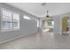 Bright living room featuring tiled floors, plentiful natural light through the windows, and a ceiling fan at 1205 Huntington Greens Dr, Sun City Center, FL 33573