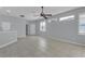 Spacious living area with tiled floors, neutral paint, and natural light, with seamless flow into other areas of the home at 1205 Huntington Greens Dr, Sun City Center, FL 33573