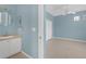 Bathroom featuring a vanity with sink and mirror, with a view into the bedroom with closet and ceiling fan at 1205 Huntington Greens Dr, Sun City Center, FL 33573