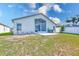 Exterior back of the house featuring screened-in porch and patio at 12821 Lake Vista Dr, Gibsonton, FL 33534