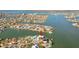 Aerial shot of the home surrounded by beautiful waterfront views and nearby cityscapes at 13 Bellevue Dr, Treasure Island, FL 33706