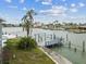 Waterfront property featuring a private boat dock with a lift, perfect for boating enthusiasts at 13 Bellevue Dr, Treasure Island, FL 33706