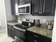 Granite counters and stainless steel appliances in a modern kitchen at 13806 Reindeer Cir, Hudson, FL 34669