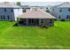 Aerial view of a backyard with covered patio, and lush green lawn at 1409 Tropical Oasis Ave, Plant City, FL 33565