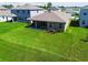 Aerial view of a backyard with covered patio, lush green lawn at 1409 Tropical Oasis Ave, Plant City, FL 33565