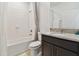 Well-lit bathroom featuring a shower-tub combo, granite vanity, and modern fixtures at 1409 Tropical Oasis Ave, Plant City, FL 33565