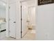 Hallway bathroom with a linen closet, toilet room, and doorway to bedroom at 1409 Tropical Oasis Ave, Plant City, FL 33565